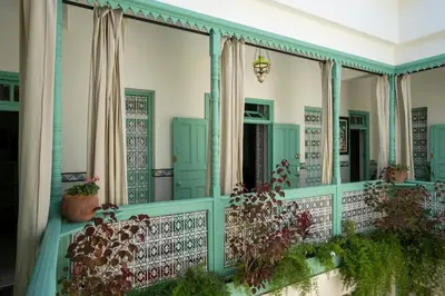 a balcony with green trim and plants at Charming Medina Riad 8 rooms with pool - Riad INN Medina in Marrakech