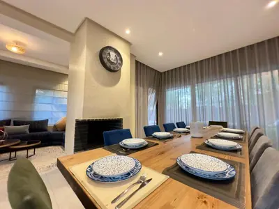 a dining room with a table and a fireplace at Villa Atlas view in Marrakech