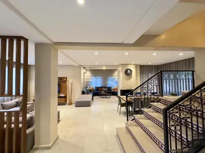 a living room with a staircase in a house at Villa Atlas view in Marrakech