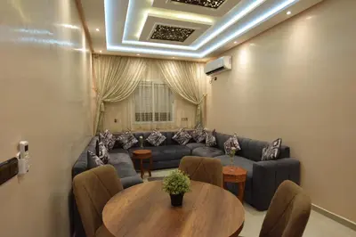 a living room with a couch and a table at Appartement familial proche aéroport et Oasiria in Marrakech