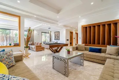 a living room with a couch and a table at Exotic villa-VIP-family only -housekeeper ,Billard,ping-pong,piscine privée chauffée-sur demande- in Marrakech