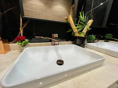 a white sink in a bathroom with plants at Exotic villa-VIP-family only -housekeeper ,Billard,ping-pong,piscine privée chauffée-sur demande- in Marrakech