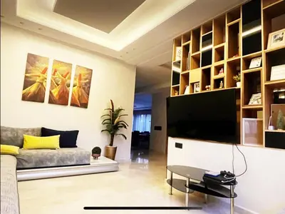 a living room with a couch and a tv at Exotic villa-VIP-family only -housekeeper ,Billard,ping-pong,piscine privée chauffée-sur demande- in Marrakech