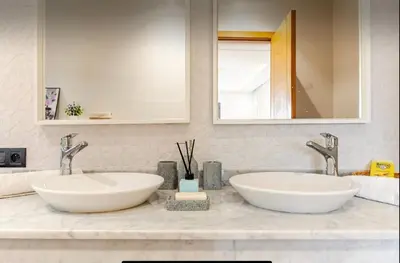 a bathroom with two sinks and a mirror at Exotic villa-VIP-family only -housekeeper ,Billard,ping-pong,piscine privée chauffée-sur demande- in Marrakech