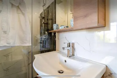 a bathroom with a white sink and a shower at Exotic villa-VIP-family only -housekeeper ,Billard,ping-pong,piscine privée chauffée-sur demande- in Marrakech