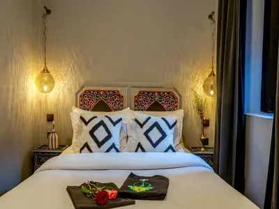 a bedroom with a bed with two roses on it at Riad Irhalne in Marrakech
