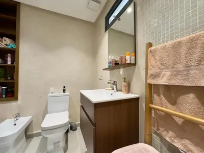 a bathroom with a toilet and a sink and a mirror at Villa Oasis in Marrakech
