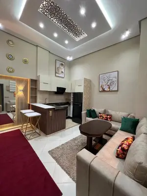 a living room with a couch and a kitchen at Appartement 1 chambre in Marrakech