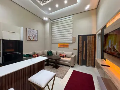 a living room with a couch and a tv at Appartement 1 chambre in Marrakech