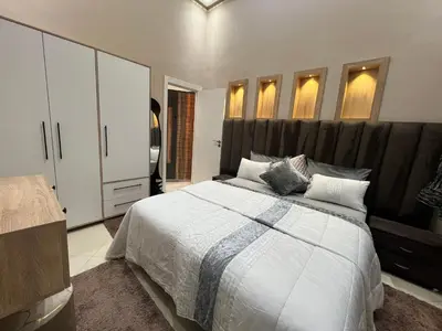 a bedroom with a large bed with a large headboard at Appartement 1 chambre in Marrakech
