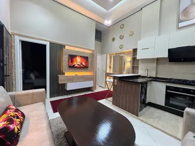 a living room with a fire in the fireplace at Appartement 1 chambre in Marrakech