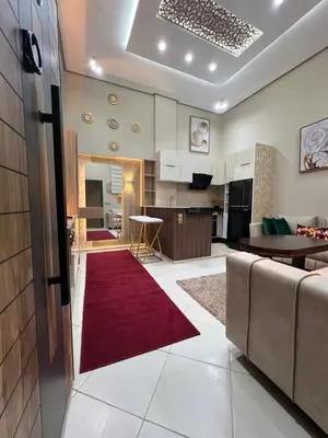 a living room with a couch and a red rug at Appartement 1 chambre in Marrakech