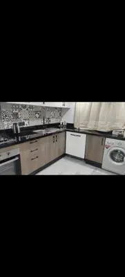 a kitchen with a sink and a washing machine at Élégant duplex avec deux piscines et une vue magnifique in Marrakech