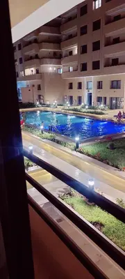 a view of a swimming pool from a window at Élégant duplex avec deux piscines et une vue magnifique in Marrakech