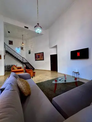 a living room with a couch and a table at Duplex Mirador Majorelle in Marrakech
