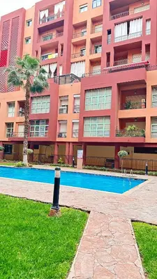 a large building with a swimming pool in front of a building at Duplex Mirador Majorelle in Marrakech