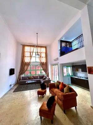 a large living room with a couch and chairs at Duplex Mirador Majorelle in Marrakech
