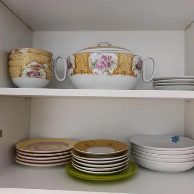 a bunch of plates and bowls in a closet at Appartement près du hôtel IBIS et WAZO et Marjane Mall in Marrakech
