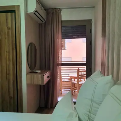 a bedroom with a bed and a desk and a window at Appartement près du hôtel IBIS et WAZO et Marjane Mall in Marrakech