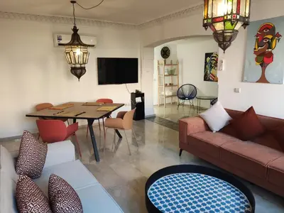 a living room with a couch and a table at Appartement à Marrakech Babylon 2 Hivernage in Marrakech