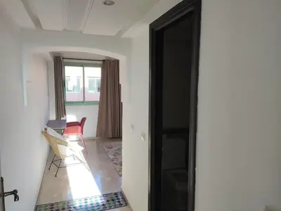 a room with a door and a chair in it at Appartement à Marrakech Babylon 2 Hivernage in Marrakech