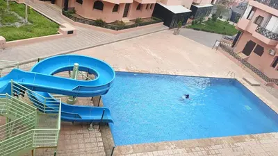 an overhead view of a water slide in a pool at premium village M355 in Marrakech