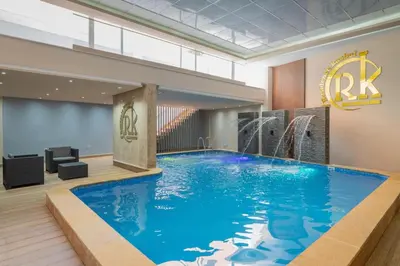 a large blue swimming pool in a hotel lobby at Appartement chic Gueliz kasbel 211 in Marrakech