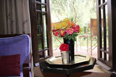 a vase of flowers on a table in a room at Dar Zemora in Marrakech