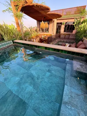 a swimming pool in front of a house at Riad Lulua Exclusif 3 Chambres et Piscine Rooftop in Marrakech