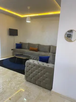 a living room with a couch and a tv at Appartement luxueux 38 nour 5 in Marrakech