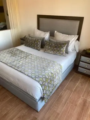 a bedroom with a large bed with pillows at Appartement luxueux 38 nour 5 in Marrakech