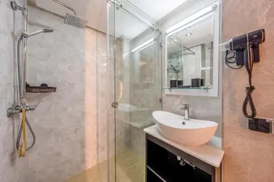a bathroom with a sink and a glass shower at Appartement de prestige Gueliz kasbel 212 in Marrakech