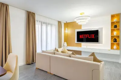a living room with a white couch and a tv at appartement hyper centre in Marrakech