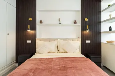 a bedroom with a large bed with a red blanket at appartement hyper centre in Marrakech