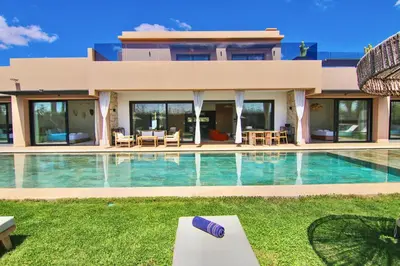 a house with a swimming pool in front of it at Villa SELINA Luxury -5 suites , Piscine privée chauffée, sans vis à vis, calme & sureté - Padle , Family only in Marrakech