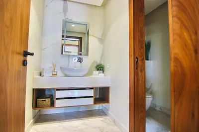 a bathroom with a sink and a mirror at Villa SELINA Luxury -5 suites , Piscine privée chauffée, sans vis à vis, calme & sureté - Padle , Family only in Marrakech