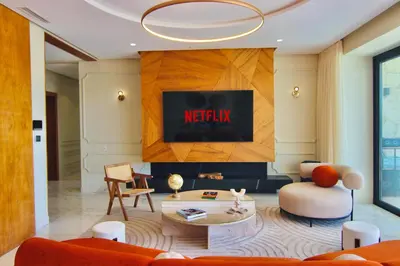 a living room with a nittisk sign on the wall at Villa SELINA Luxury -5 suites , Piscine privée chauffée, sans vis à vis, calme & sureté - Padle , Family only in Marrakech