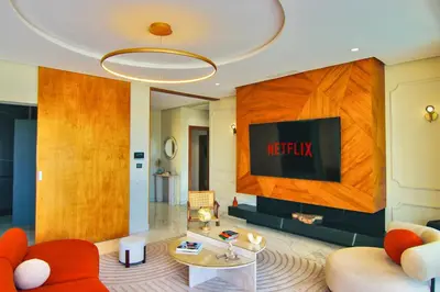 a living room with a couch and a tv at Villa SELINA Luxury -5 suites , Piscine privée chauffée, sans vis à vis, calme & sureté - Padle , Family only in Marrakech