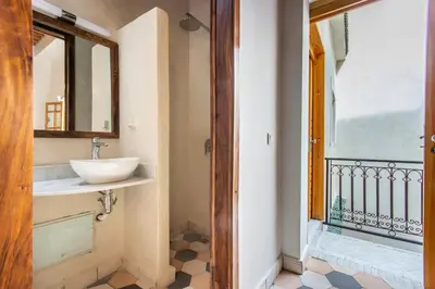 a bathroom with a sink next to a balcony at Riad Les Suites Marrakech in Marrakech