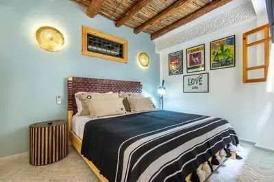 a bedroom with a large bed in a room at Riad Les Suites Marrakech in Marrakech