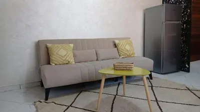 a living room with a couch and a table at APPARTENT 11 à GUELIZE HIVERNAGE in Marrakech