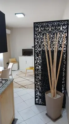 a living room with a black and white partition with sticks at APPARTENT 11 à GUELIZE HIVERNAGE in Marrakech