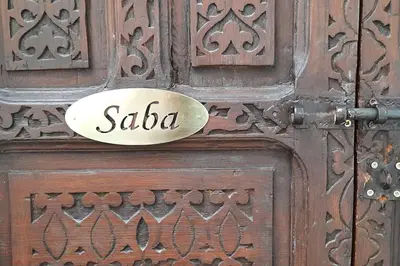 a wooden door with a sign on it at Riad Cosy in Marrakech
