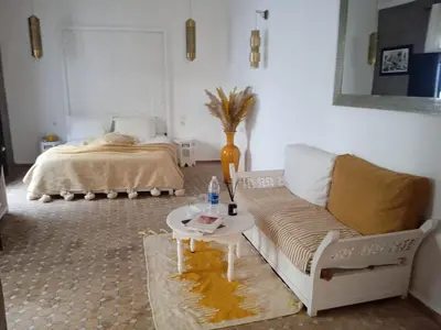 a living room with a couch and a bed at Riad Cosy in Marrakech