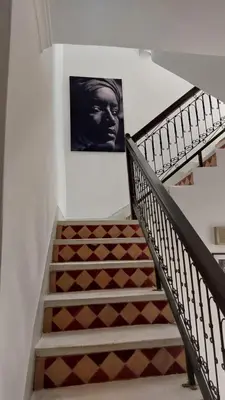 a staircase with a picture of a man on the wall at Riad Cosy in Marrakech