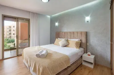 a bedroom with a bed with two towels on it at Red appart in Marrakech