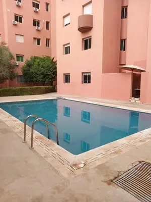 a swimming pool in front of a building at Appartement Marrakech Avec Piscine in Marrakech