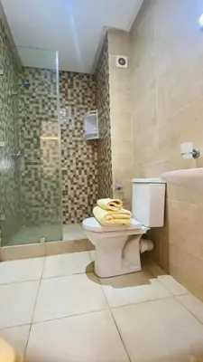 a bathroom with a toilet and a shower and a sink at Résidence nour 5 in Marrakech