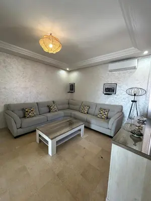 a living room with a couch and a coffee table at Appartement 3 chambres Gueliz Hivernage Marrakech centre 5 Etage M21 in Marrakech