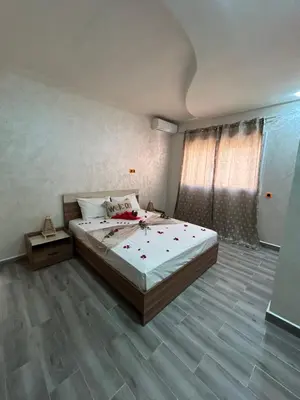 a bedroom with a large bed and a wooden floor at Appartement 3 chambres Gueliz Hivernage Marrakech centre 5 Etage M21 in Marrakech
